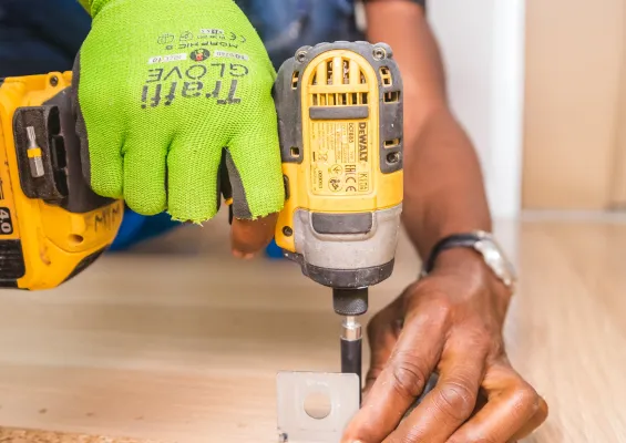 Flooring Installer using a drill