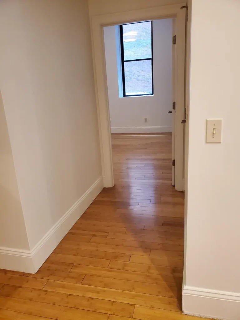 Evened-out subfloor surface after leveling in living room area.