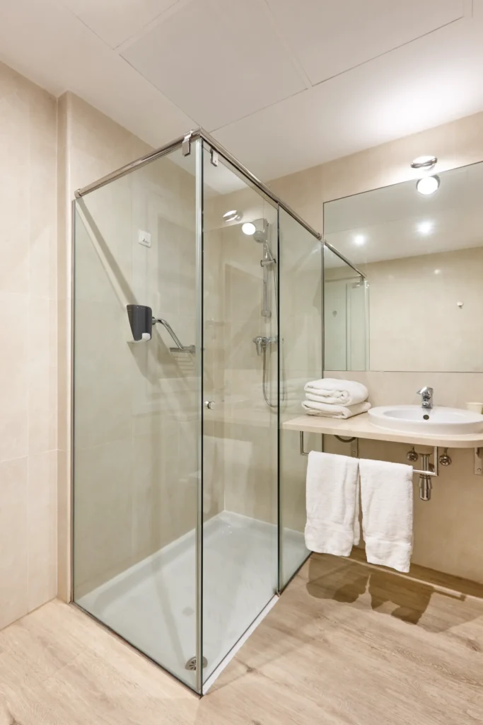Shower with glass enclosure in a modern bathroom.