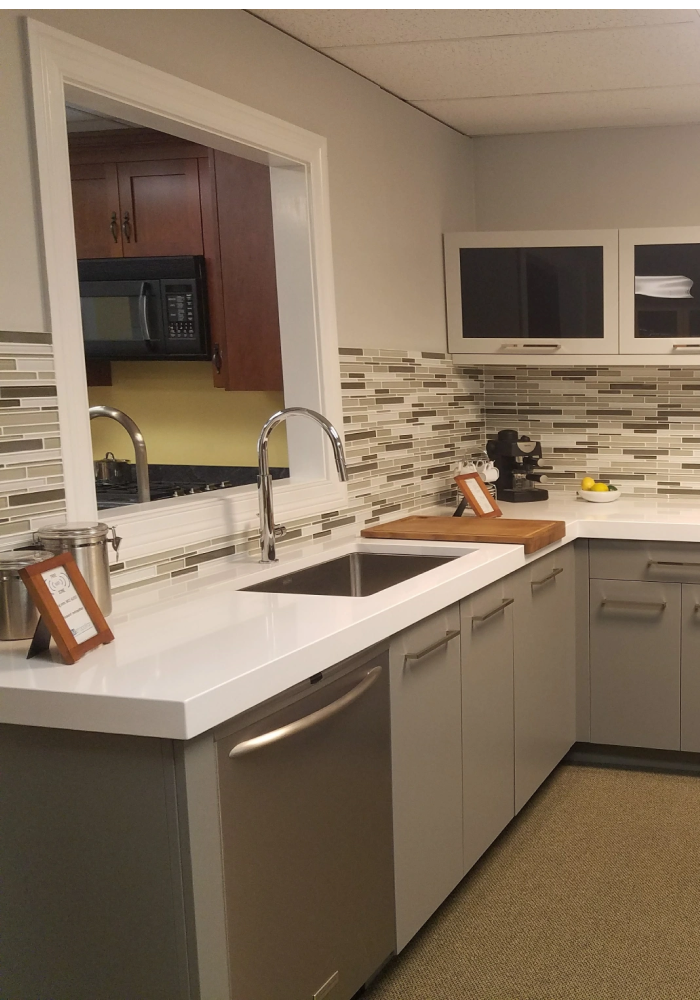 White kitchen with marble countertop.