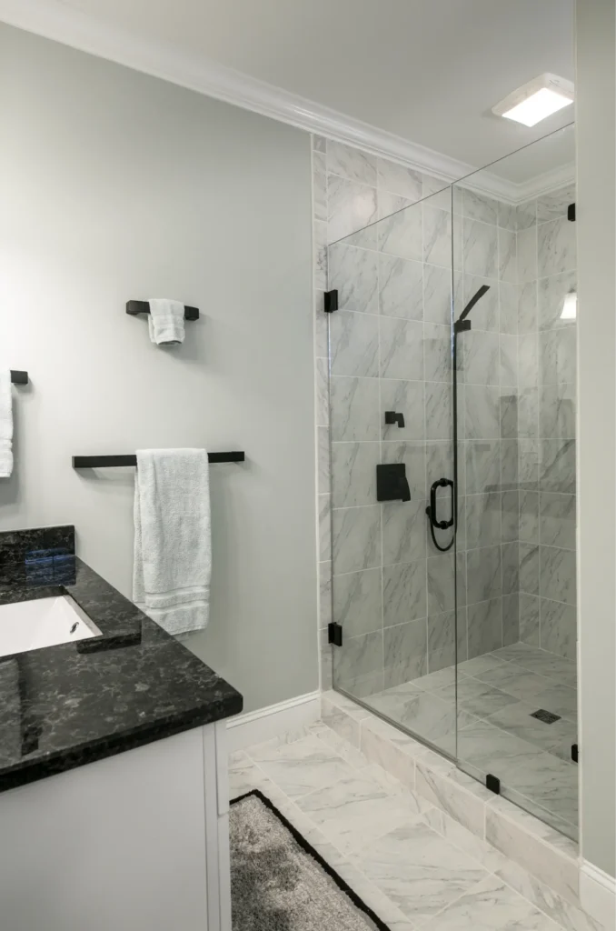 modern bathroom with glass shower enclosure.