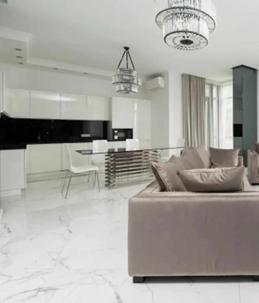 Tile flooring being installed in the living room with grey ceramic tiles.