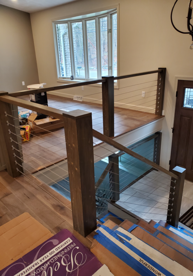 Worn-out wood stairs and handrails before refinishing.
