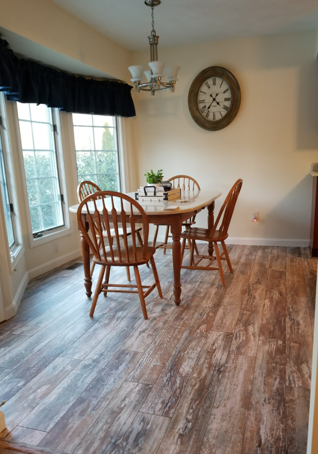Hardwood floor installation in progress in a spacious living room.