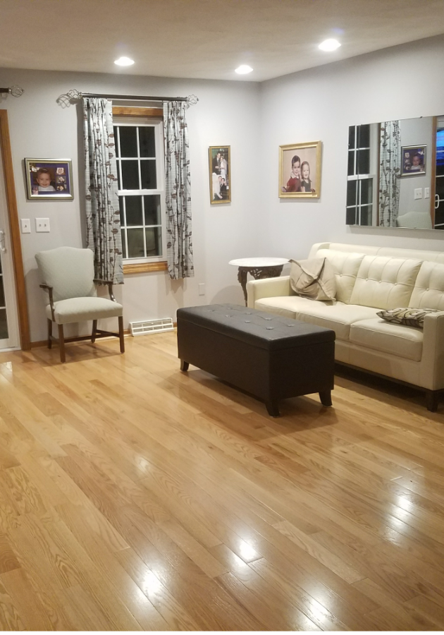 Laminate flooring planks being installed in living room.