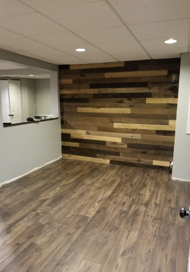 Completed laminate flooring with light oak finish in modern kitchen.