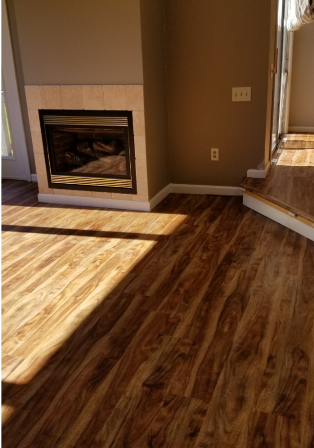 Refinished light oak hardwood flooring in sunlit living area