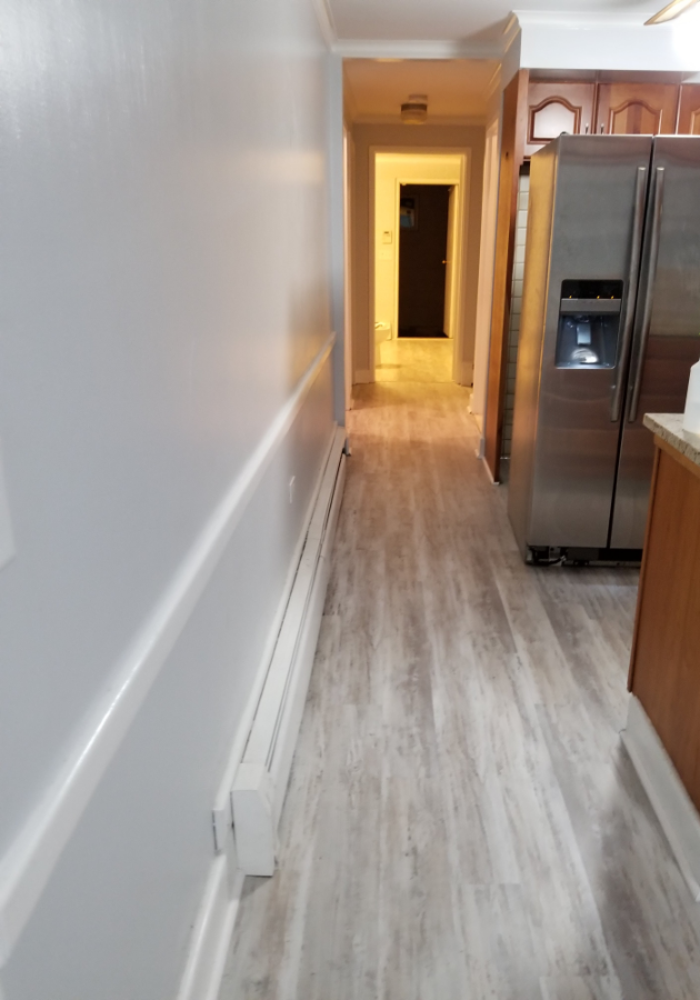 Completed LVP flooring with grey oak finish in kitchen